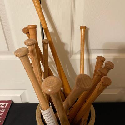 Antique crock filled with small baseball bats