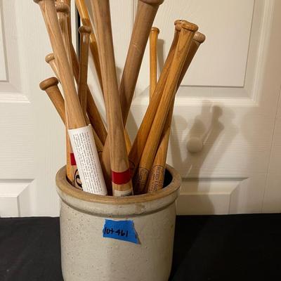 Antique crock filled with small baseball bats