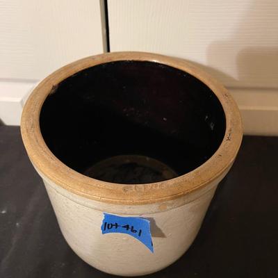 Antique crock filled with small baseball bats