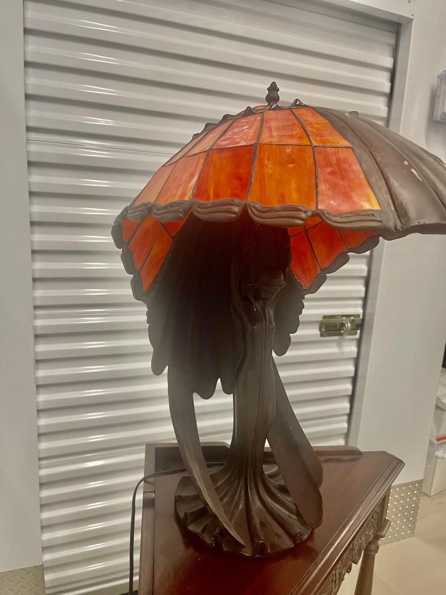 Beautiful Flying Lady Tiffany style table lamp. Solid bronze. 3 bulbs. 26” x 16” |