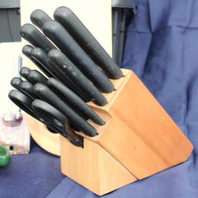 Assorted kitchenware; cutlery, plastic cups, coffee maker, plastic pitcher, meat thermometer, chopping board, black handle knife set and...