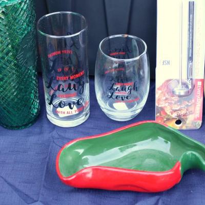 Assorted kitchenware; cutlery, plastic cups, coffee maker, plastic pitcher, meat thermometer, chopping board, black handle knife set and...
