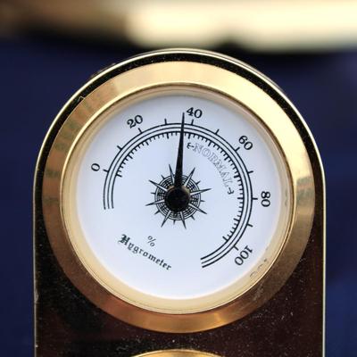 Glass encased clock. Plastic. Made in Japan. And Small Crystal Melody Quartz Hygrometer and clock
