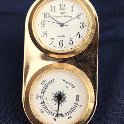 Glass encased clock. Plastic. Made in Japan. And Small Crystal Melody Quartz Hygrometer and clock