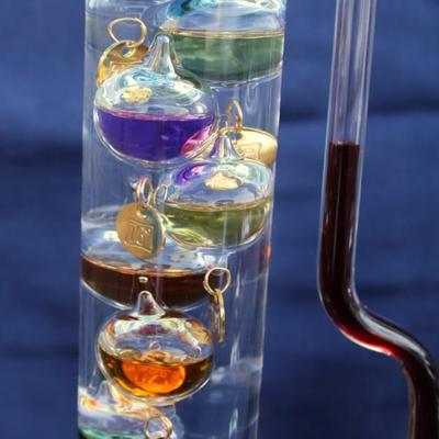 Set of 2 Galileo thermometers (20" and 14"); multi-colored spheres. Some water evaporation.