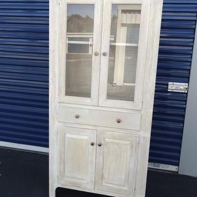 One drawer hutch, open bottom shelf and two enclosed shelves with glass doors.