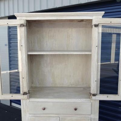 One drawer hutch, open bottom shelf and two enclosed shelves with glass doors.