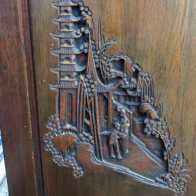 Oriental chest of drawers; carvings on drawer fronts and sides of dresser