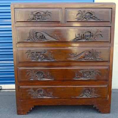 Oriental chest of drawers; carvings on drawer fronts and sides of dresser
