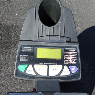 Exercise bike with built in small weights rack.