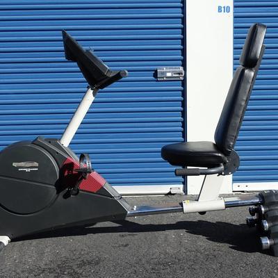 Exercise bike with built in small weights rack.
