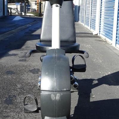 Exercise bike with built in small weights rack.