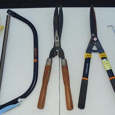 Assorted gardening tools and work gloves.