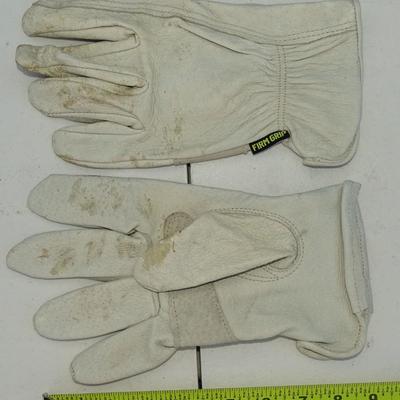 Assorted gardening tools and work gloves.