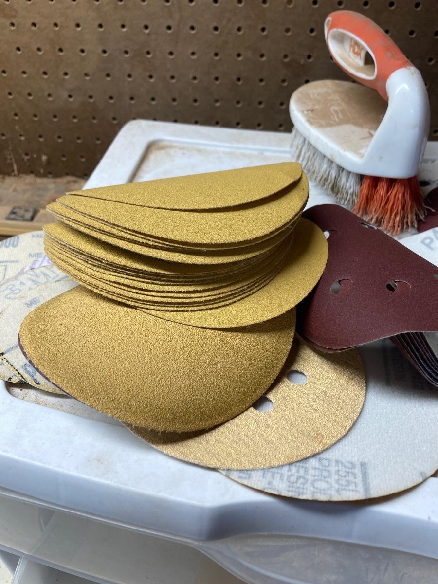 SANDPAPER, STORAGE CONTAINER, AND SCRUB BRUSH