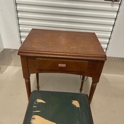 Vintage singer sewing machine, cabinet and. Bench. Includes  box of attachments And  vintage patterns