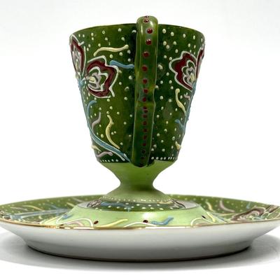 Green painted pattern tea cup and saucer