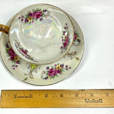 Flower patterned and lime green tea cup and saucer