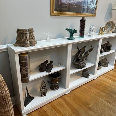 Three white bookshelves