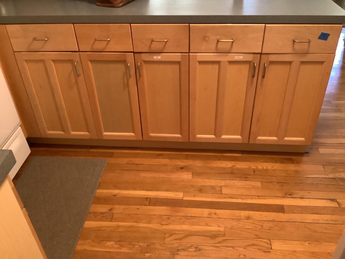 Right of stove, under long counter/ island construction grade