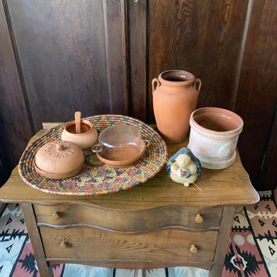 Group of terra cotta items with a decorative woven basket