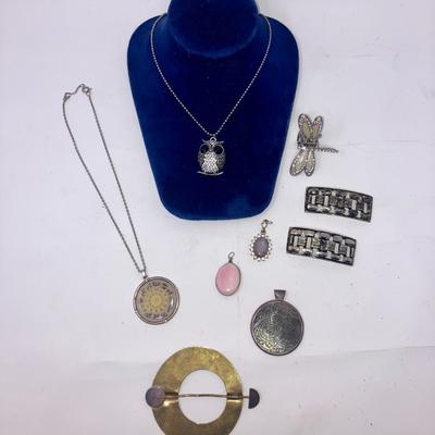 Lot of costume fashion accessories including pendants hair clip shoe clips and necklaces