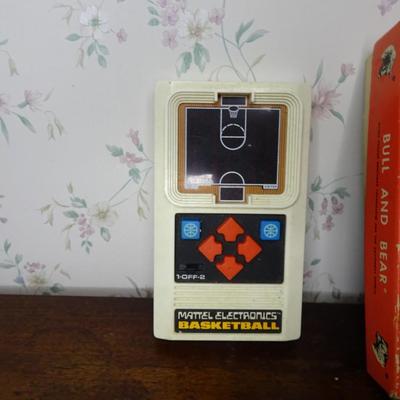 LOT 243. VINTAGE BASKETBALL ELECTRONIC GAME, VINTAGE PIT GAME AND MISC GAMES