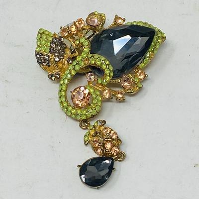Lot of decorative lapel pins and 3 pair of earrings