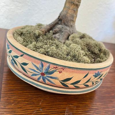 Fake flower arrangement in clay pot