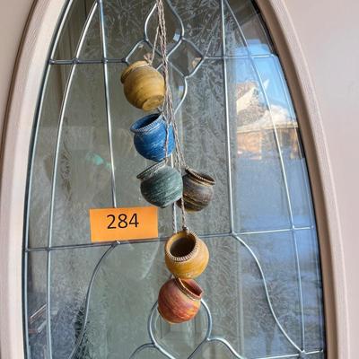 Wall display of pots on a rope