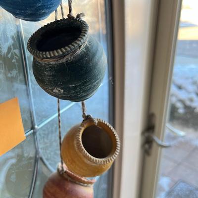 Wall display of pots on a rope