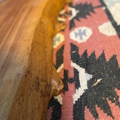Slab of wood, live edge on one edge, finished on one side