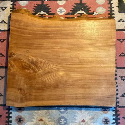 Slab of wood, live edge on one edge, finished on one side