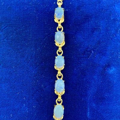 Suite of 10K gold rings and a bracelet with opal and white stone.