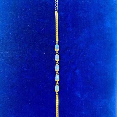 Suite of 10K gold rings and a bracelet with opal and white stone.