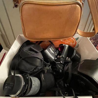 Box of cameras, lenses, bags