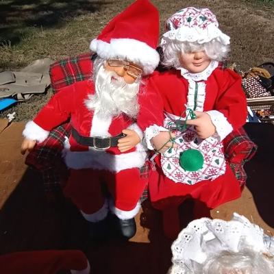 SLEEPING MR & MRS CLAUSE AND BOTH ON BENCH