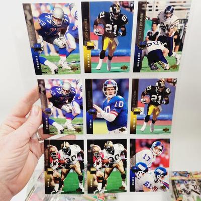 234 COLLECTABLE FOOTBALL CARDS IN PROTECTIVE SLEEVES - ROOKIES INCLUDED