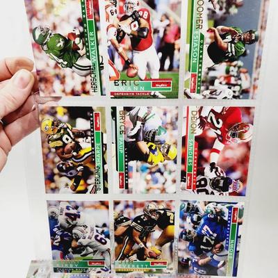 234 COLLECTABLE FOOTBALL CARDS IN PROTECTIVE SLEEVES - ROOKIES INCLUDED