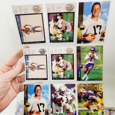 234 COLLECTABLE FOOTBALL CARDS IN PROTECTIVE SLEEVES - ROOKIES INCLUDED