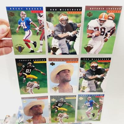 234 COLLECTABLE FOOTBALL CARDS IN PROTECTIVE SLEEVES - ROOKIES INCLUDED