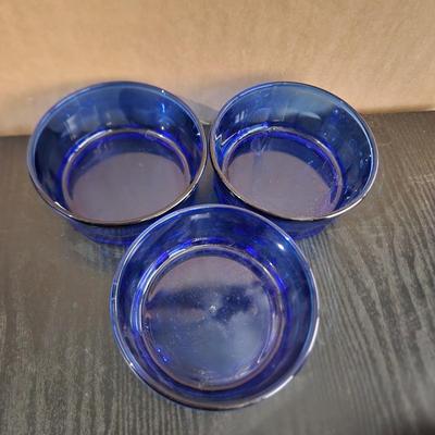 Three blue glass bowls