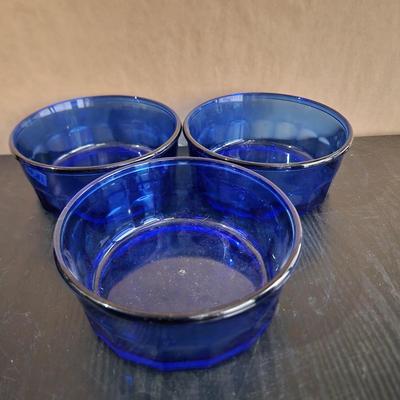 Three blue glass bowls