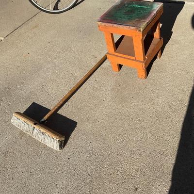 Small stool and shop broom.