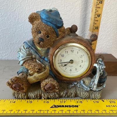 Teddy bear figurine with clock