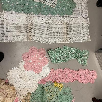 Lot of vintage hand-crocheted doilies and table runners.  40 doilies and 12 table runners.