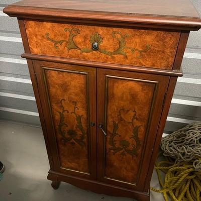 Vintage wine cabinet. Has storage shelf on top of inside of cabinet and wine racks for wine bottles. One handle is off. It it can be...