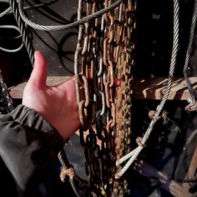 Large Lot of Chains, Metal Cables, Hooks, and Pulley of Varying Sizes and Lengths