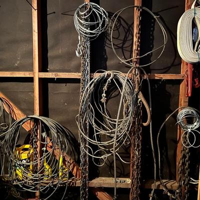 Large Lot of Chains, Metal Cables, Hooks, and Pulley of Varying Sizes and Lengths