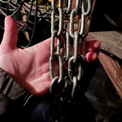 Large Lot of Chains, Metal Cables, Hooks, and Pulley of Varying Sizes and Lengths